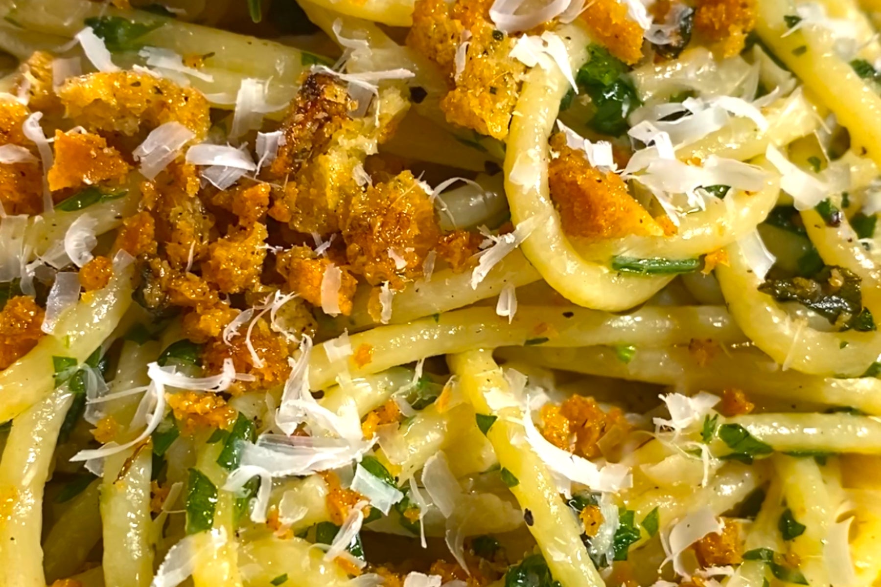 Spaghetti noodles with crunchy crouton breadcrumbs and parmesan cheese.