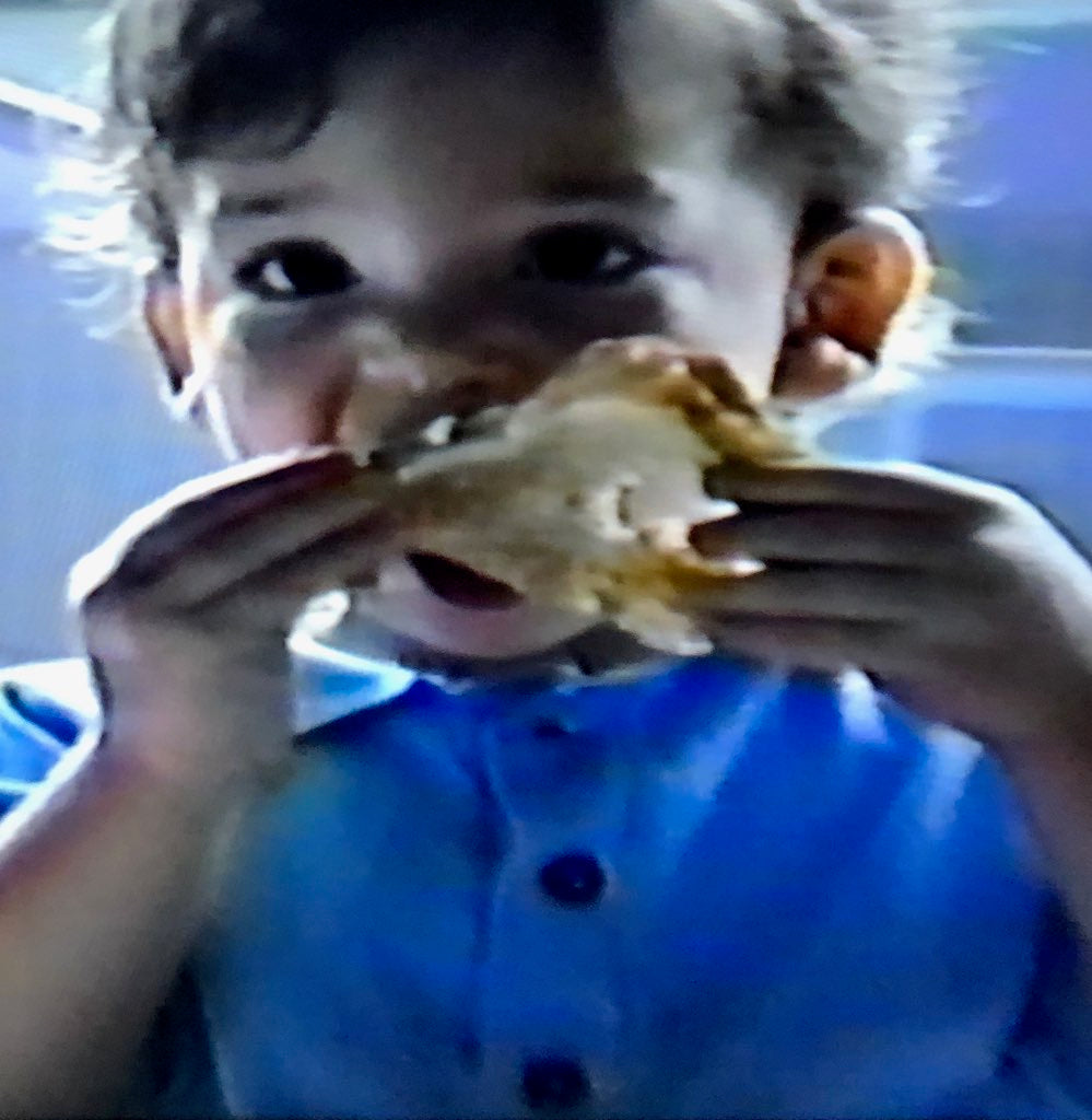 Childhood photograph of one of the company founders eating a slice of bread as a baby.