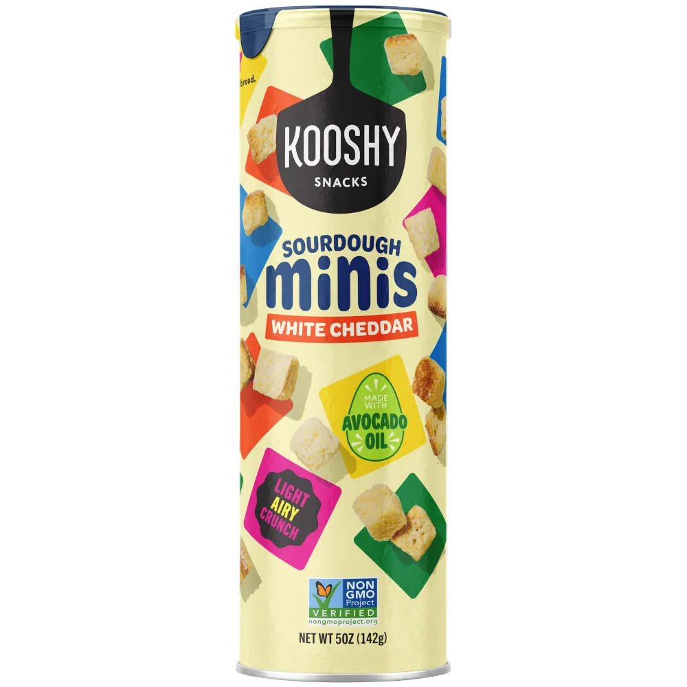 A tall cylindrical canister of Kooshy Sourdough Minis White Cheddar on a plain white background. The packaging features a pale yellow base with colorful geometric snack illustrations and prominent black, blue, red, green, and pink label elements.